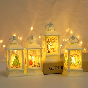Detail of four white Christmas lanterns with warm lights featuring Santa and reindeer