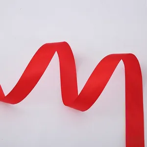 Detailed view of red satin ribbon with smooth texture for Christmas gift wrapping