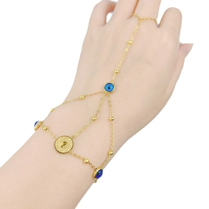 Elegant gold evil eye finger bracelet with blue beads and a vintage coin charm for women