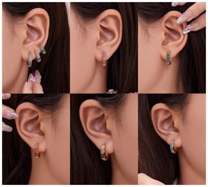 Detail of six mini gold hoop earrings with multi-colored zirconia stones on ear