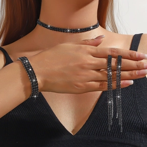 Detail of elegant black rhinestone jewelry set with double layer choker and tassel earrings