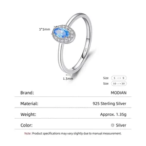Polished 925 sterling silver ring with oval blue gemstone and cubic zirconia halo