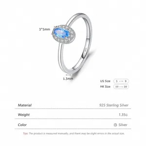Polished 925 sterling silver ring with oval blue gemstone and cubic zirconia halo