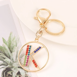 Detail of gold keychain letter K featuring vibrant multicolor rhinestones and lobster clasp