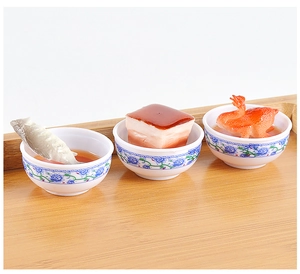 Detailed macro view of miniature resin food bowls featuring braised pork and fish
