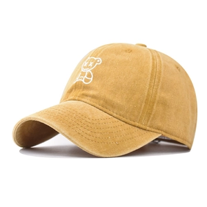 Close-up of yellow washed cotton baseball cap featuring detailed white bear embroidery