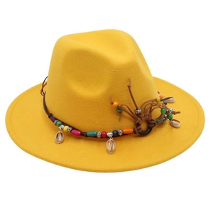 Detail of yellow fedora wool hat with bohemian beaded band and seashell accents