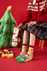 Detail of warm coral fleece Christmas socks featuring festive embroidery and soft textures