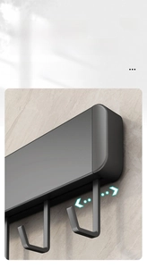 Detail of adjustable black kitchen rack with sliding solid J-shaped hooks on marble wall