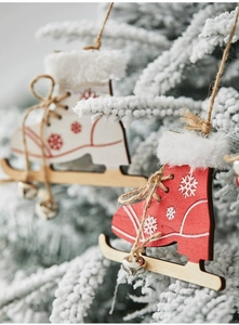 Close-up of wooden ice skate ornaments with plush trim and bells for Christmas trees