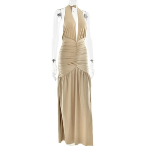 Detail of elegant beige V-neck backless pleated dress with ruched waist on mannequin