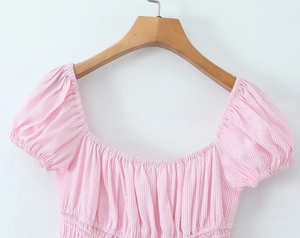 Detail of pink and white striped puff sleeve top with a square neck and elastic waist
