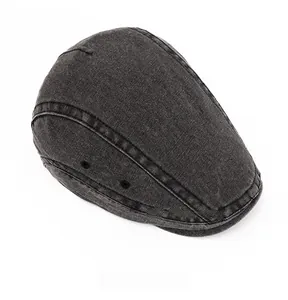 Detailed top view of a washed charcoal denim flat cap featuring black metal eyelets