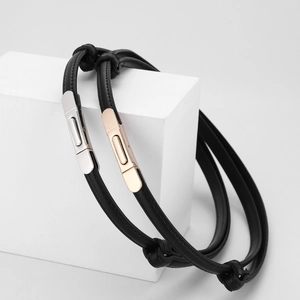 Minimalist black leather belt for women featuring silver and rose gold metal clasps