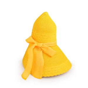 Detail of yellow straw sun hat featuring a large woven bow and intricate texture