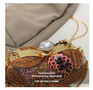 Close-up of golden embroidery and pink floral sequins with a large crystal clasp on a bag