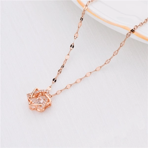 Macro shot of 18K rose gold titanium star necklace with sparkling dancing zircon pendant