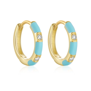 Macro shot of gold S925 silver hoop earrings with turquoise enamel and small diamonds
