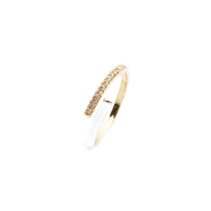 Detailed macro view of adjustable gold ring with sparkling pavé crystals and white enamel