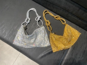 Detail of silver and gold rhinestone hobo bags with unique knotted handles and zip closure