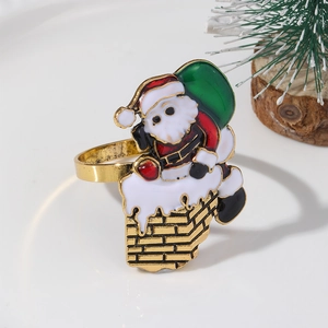 Macro detail of Santa Claus climbing a gold enamel chimney napkin ring with festive pine