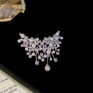 Macro shot of French vintage brooch with zircon crystals and drop pearl detail