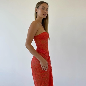 Detail of red mesh patchwork strapless dress with ruched side and slim fit silhouette