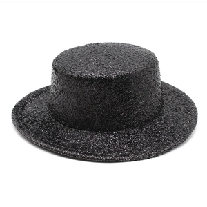 Detail of black boater hat featuring shimmering sequins and a flat top design