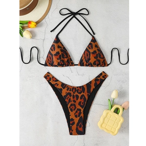 Flat lay of a leopard print triangle bikini set with tie strings on a stone background