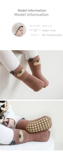 Close-up of baby floor socks with 3D bear design and yellow anti-slip silicone dots