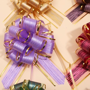 Close-up of assorted colorful gift pull bows with gold trim in various vibrant shades