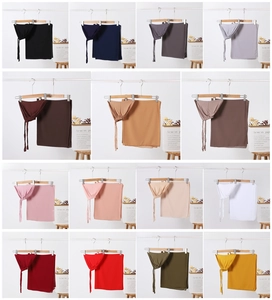 Muslim hijab set showcase featuring 16 solid colors on wooden hangers with elegant decor