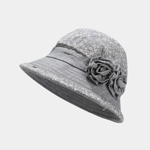 Detail view of breathable grey floral sun hat for elderly women with handcrafted fabric flower