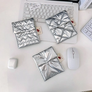 Detailed view of silver quilted organizer pouch with metallic finish and snap button closure