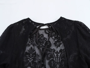 Détails de dentelle florale noire avec motifs ajourés et ruban de serrage élégant sur la robe