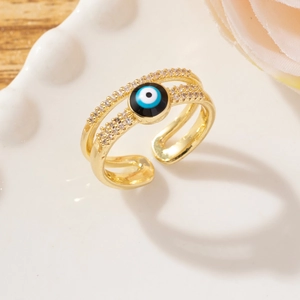Macro detail of gold adjustable evil eye ring with micro-pave cubic zirconia crystals
