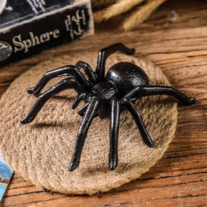 Nordic vintage black realistic spider model on rustic hemp mat for Halloween decor