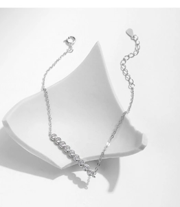 Detail of adjustable silver bracelet with nine round zircon stones in bezel setting