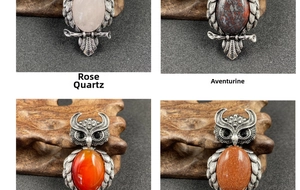 Macro view of owl pendants set with rose quartz and rainbow stones on vintage silver metal