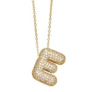 Close-up of golden balloon letter E pendant encrusted with pavé sparkling crystals