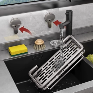 Stainless steel sink caddy with drain holes and towel bar shown under running water