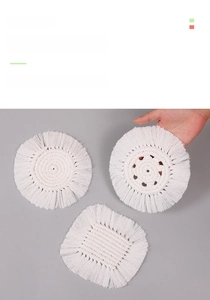 Detail showing the hand-woven cotton texture and white fringes of macrame coasters