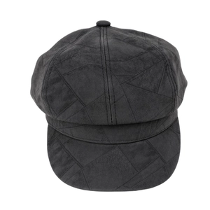 Detailed top view of a dark grey suede newsboy hat featuring geometric stitching patterns