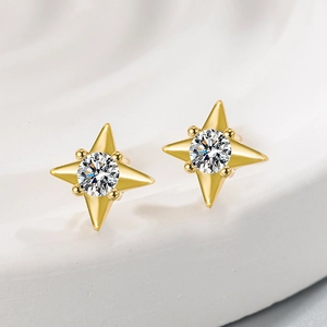 Elegant gold four-pointed star stud earrings with sparkling cubic zirconia on white background