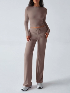 Detail of soft brown knitted two-piece set featuring drawstring pants and long sleeve top