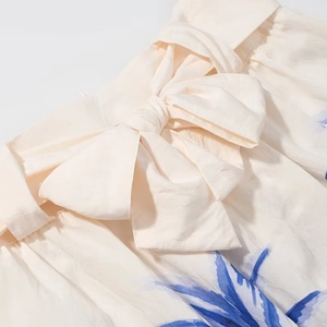 Women's island style sleeveless top and midi skirt set with bow-tie and blue floral print