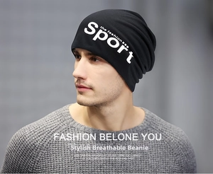 Side view of a male model wearing a black knit beanie with sport lettering print