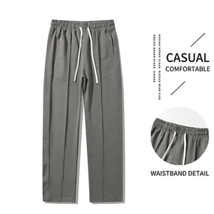 Men's light grey loose straight sports trousers with drawstring waist and seam detail