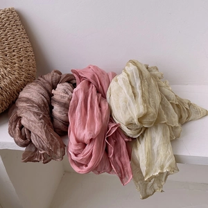 Pleated vintage silk scarves in brown, pink, and yellow colors with soft crinkle texture