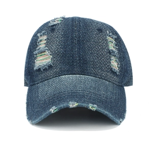 Detail of distressed navy denim baseball cap with rainbow stitching and ripped edges